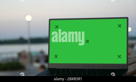 Laptop on a bench in a street. Stock Photo