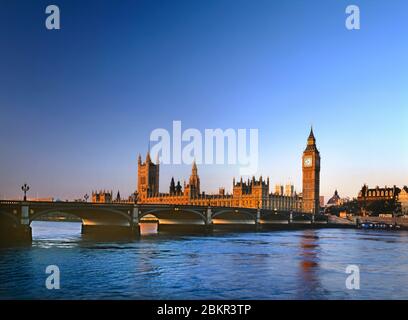 Houses of Parliament & Westminster Bridge illuminated by clear red dawn sunrise River Thames at high tide from South Bank London UK Stock Photo