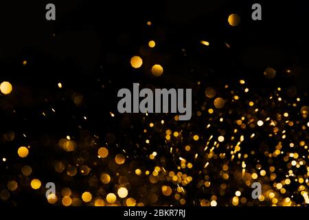 Splash of golden sparkles on black background. Stock Photo