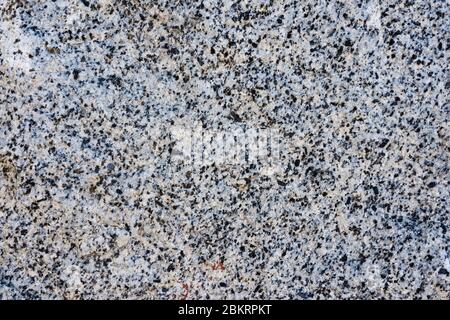 The texture of light pink natural granite with black spots Stock Photo