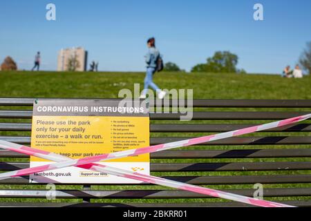 Brockwell Park, UK. 5th May, 2020. Park benches are closed and sealed off with red and white tape to help stop the spread of Coronavirus in Brockwell Park, South London, during the Coronavirus Lockdown. Brockwell Park is a 50.8 hectare park located south of Brixton, adjacent to Herne Hill and Tulse Hill in south London, England. (Credit: Sam Mellish/Alamy Live News) Stock Photo
