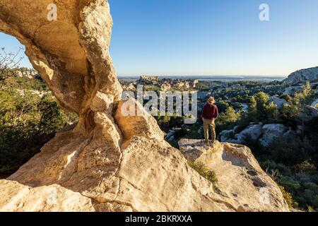 France, Bouches-du-Rh?ne, Alpilles regional natural park, Les Baux de Provence, labeled Les Plus Beaux Villages de France, Val d'Enfer, cliff pierced by caves, the village and the castle in ruins behind -plan Stock Photo