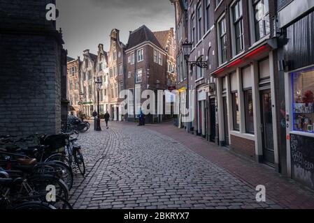 Amsterdam, Netherlands - February 2016:, Crooked house and cobbled streets in the Red Light Area Stock Photo