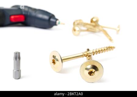 torx head bit, yellow zinc torx screws and electric screwdriver, isolated on white. Stock Photo