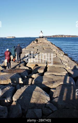 Portland, Maine, US - 20.11.2019: lighthouse on harbor in Portland Maine ME, SPRING POINT LEDGE LIGHTHOUSE is at end of breakwater of large boulders Stock Photo