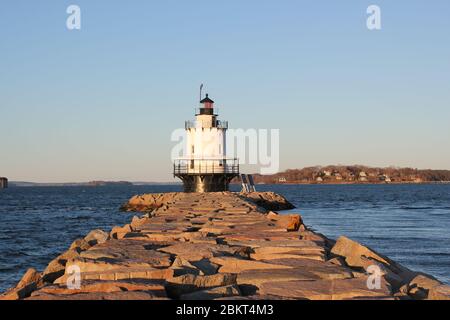 Portland, Maine, US - 20.11.2019: lighthouse on harbor in Portland Maine ME, SPRING POINT LEDGE LIGHTHOUSE is at end of breakwater of large boulders Stock Photo