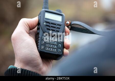 Close up of male holding walkie talkie. Stock Photo