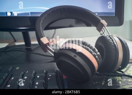 Stereo headphones on the keyboard of a computer Stock Photo