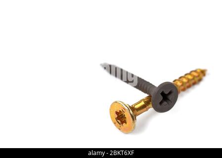golden screw and black screws Close-up. wood screws on white background. isolated Stock Photo