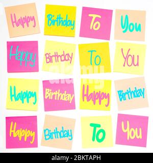 A square grid pattern with rows of pastel coloured sticky notes or adhesive notes with the song lyrics for Happy Birthday To You printed on Stock Photo