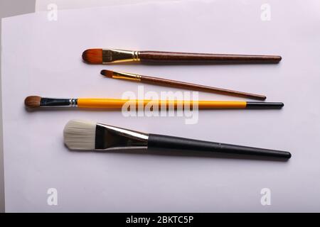Art brushes of different sizes on a white background. Four brushes for painting, horisontal shot Stock Photo