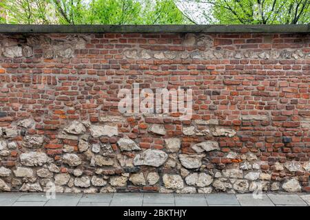 Background old brick wall with small and big stones Stock Photo