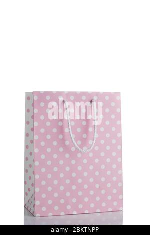 pink polka dot paper shopping bag isolated on white background. Mockup for design. sale concept. Stock Photo