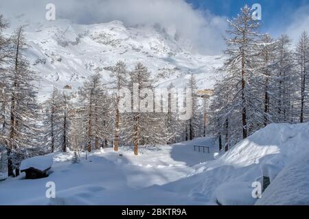 View Italian Alps and Matterhorn Peak under the clouds in December, Breuil-Cervinia, Valle d'Aosta, Italy Stock Photo