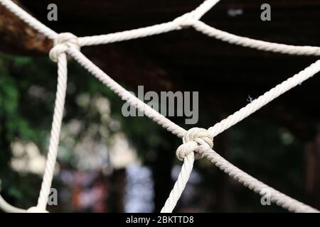 Large knot made of natural hemp. The know it part of kids' playground equipment in Switzerland. A know is a symbol for nautical life, cooperation, etc Stock Photo