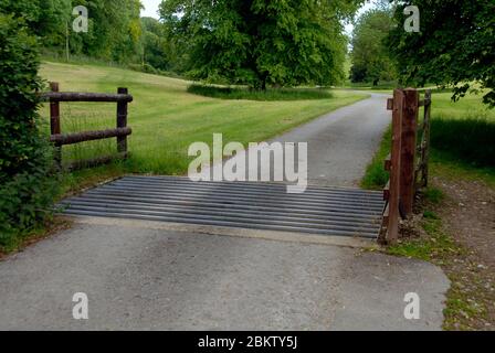 Cattle grid, on private road, to prevent cattle crossing, although in this case there is a bypass beside the crossing. It also slow vehicular traffic. Stock Photo
