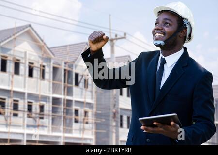 Portrait of success african industrial engineer manager standing with the building in background. Stock Photo