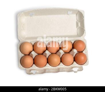 Ten brown eggs in a carton package. Top view. Ten brown eggs in a cardboard box. Eggs. Stock Photo