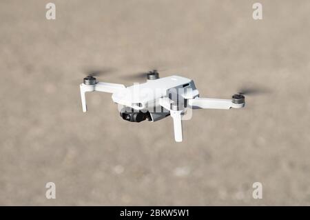 DJI Mavic Mini drone quadcopter inflight in flight hovering flying Stock Photo