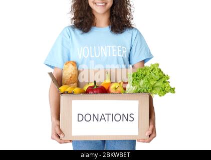 Smiling woman courier volunteer holding social food donations box close up. Stock Photo