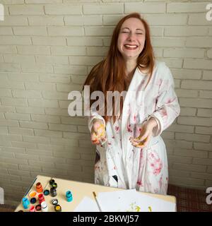 A girl paints a picture with colors using her own hands Stock Photo