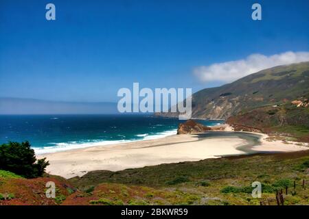Sandy beach where the Little Sur River empties into the Pacific Ocean. Stock Photo
