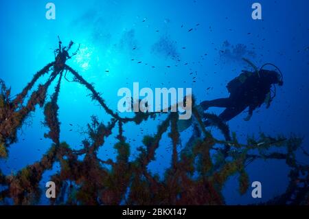 Scuba diver and an entangled fishing net in Hermanos Florin shipwreck in Ses Salines Natural Park (Formentera, Pityuses, Mediterranean sea, Spain) Stock Photo