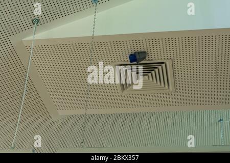 White sound absorption ceiling with duct grilles and lights Stock Photo