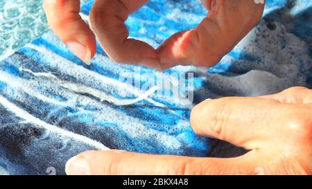 Merino wool being wet felted with sudsy water for a garment by textile artist Michelle Reid Stock Photo