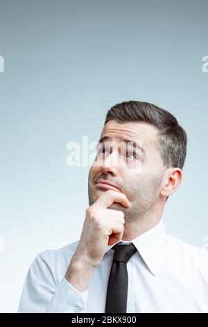 Contemplative middle-aged man in casual wear stands outside, his gaze ...