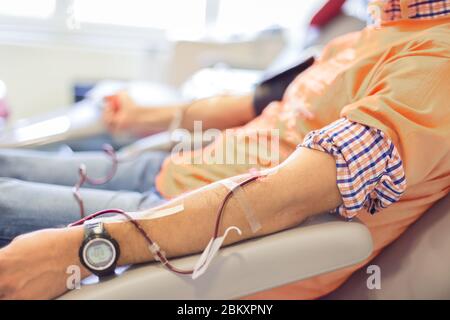 Blood donor at donation with a bouncy ball holding in hand Stock Photo