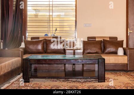 Burgundy leather sofas and wooden coffee table in living room Stock Photo