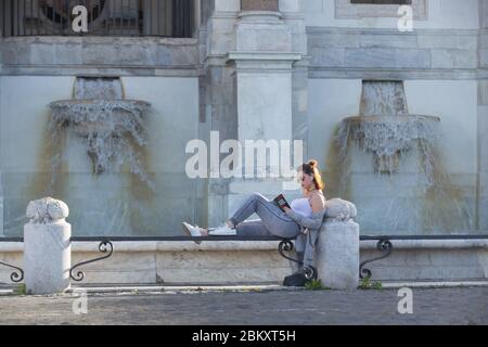 Roma, Italy. 05th May, 2020. A girl reads a book by Gabriel Garcia Marquez at sunset on the edge of Acqua Paola Fountain, also called 'Fontanone' (Photo by Matteo Nardone/Pacific Press) Credit: Pacific Press Agency/Alamy Live News Stock Photo