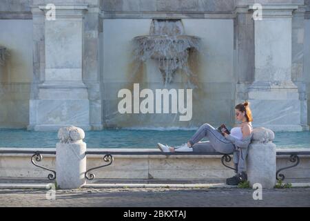 Roma, Italy. 05th May, 2020. A girl reads a book by Gabriel Garcia Marquez at sunset on the edge of Acqua Paola Fountain, also called 'Fontanone' (Photo by Matteo Nardone/Pacific Press) Credit: Pacific Press Agency/Alamy Live News Stock Photo