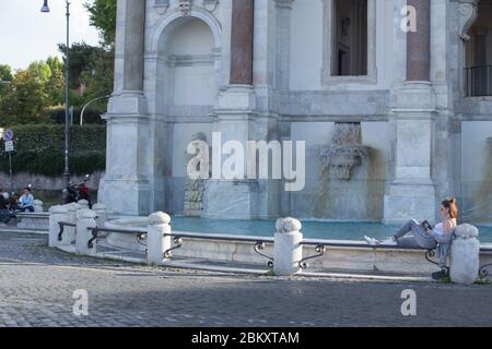 Roma, Italy. 05th May, 2020. A girl reads a book by Gabriel Garcia Marquez at sunset on the edge of Acqua Paola Fountain, also called 'Fontanone' (Photo by Matteo Nardone/Pacific Press) Credit: Pacific Press Agency/Alamy Live News Stock Photo