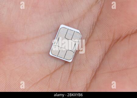 Nano sim card on hand, mobile sim card closeup Stock Photo