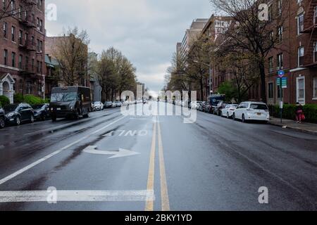 Brooklyn, NY - 18 April 2020. At noon on a Saturday, the normally busy Ocean Avenue at Avenue J is without traffic—one car in the far distance and a U Stock Photo