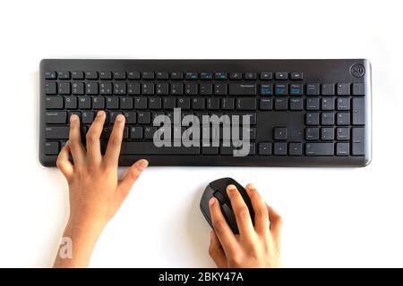 Closeup of person hand typing on keyboard with mouse, clipping path on white Stock Photo