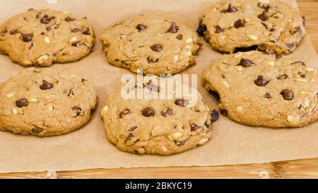 Chocolate Chip Cookies with pine nuts close up on wooden background. Homemade old-fashioned Chocolate Chip Cookies. American cuisine, dessert Stock Photo