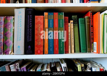 Harry Potter, The Hobbit, and Lord of the Rings book spines on a bookshelf at home; personal collection of children's and young adult literature. Stock Photo