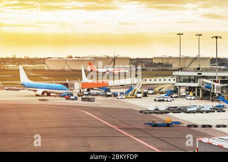 Airport with airplanes at the terminal gate ready for takeoff, international airport during sunset Stock Photo