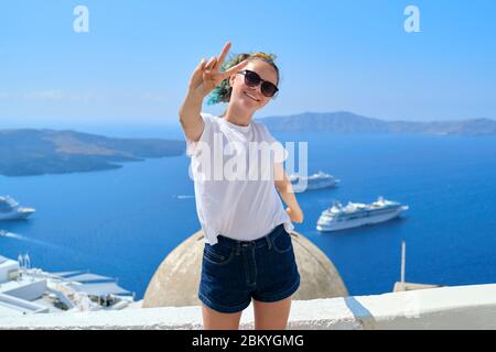 Teenager girl smiling, background sea landscape with white cruise liners Stock Photo