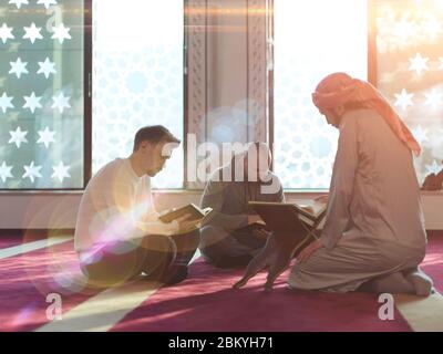 muslim people in mosque reading quran together concept of islamic education and school of holly book kuran Stock Photo