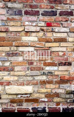 Old multi colored old brick wall Stock Photo