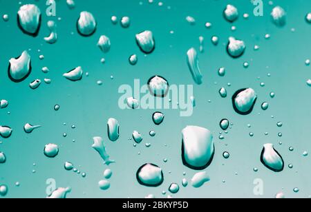 Turquoise, blue water drops background. Water drops on the glass. Abstract backdrop. Graphic sources. Stock Photo