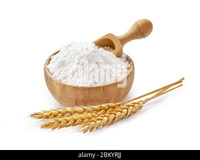 Wheat flour in bowl and spikelets isolated on white Stock Photo