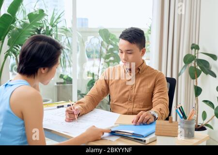 Confident team of engineers working together in a architect studio Stock Photo