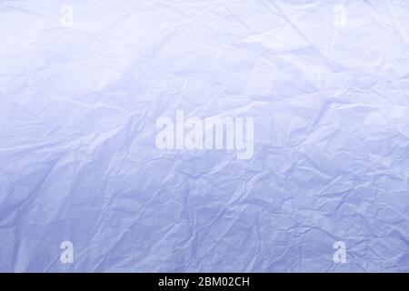 Texture of crumpled navy blue wrapping paper with white gradient, closeup. Light lilac old vintage background. Material backdrop Stock Photo