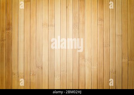 Texture of wooden light brown background with vignette. Bamboo beige traditional napkin for a table. Stock Photo