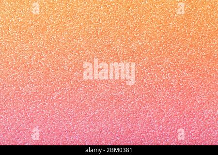 Texture of old light pink paper background with coral gradient, closeup. Structure of dense rose craft cardboard. Stock Photo